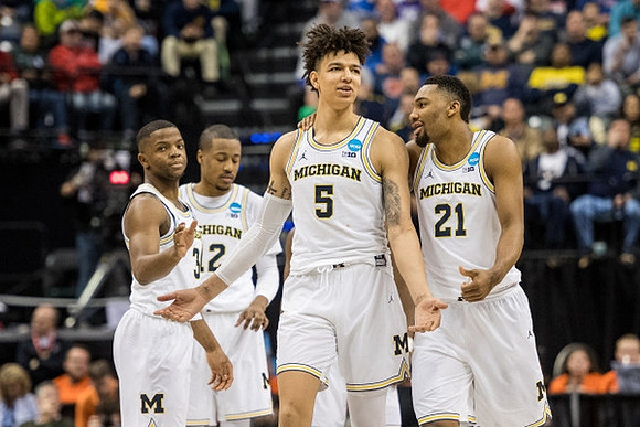 Xavier Simpson (3), Muhammad-Ali Abdur-Rahkman (12), D.J. Wilson (5), and Zak Irvin (21)