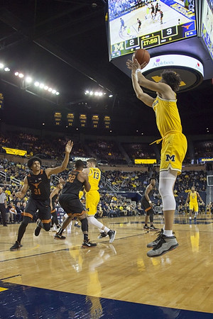 Moritz Wagner (13), D.J. Wilson (5), and Zak Irvin (21)