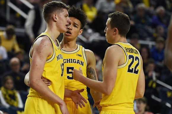Moritz Wagner (13), D.J. Wilson (5), and Duncan Robinson (22)