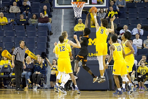 Muhammad-Ali Abdur-Rahkman (12), Moritz Wagner (13), D.J. Wilson (5), Derrick Walton Jr. (10), and Zak Irvin (21)