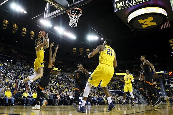 D.J. Wilson (5), Zak Irvin (21), and Muhammad-Ali Abdur-Rahkman (12)