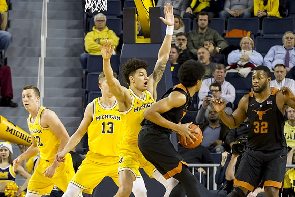 Duncan Robinson (22), Moritz Wagner (13), and D.J. Wilson (5)
