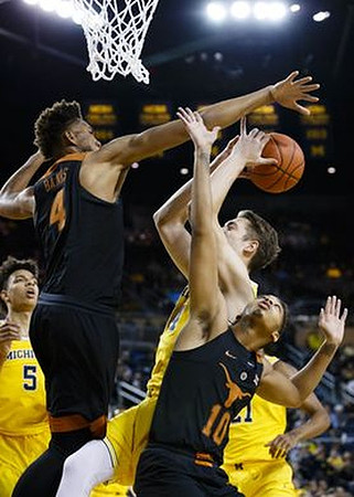 D.J. Wilson (5), Mark Donnal (34), and Zak Irvin (21)