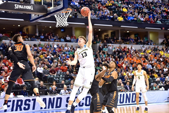Moritz Wagner (13) and D.J. Wilson (5)