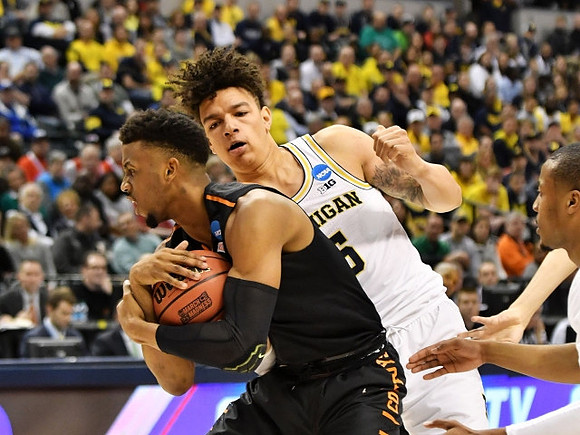 D.J. Wilson (5) and Muhammad-Ali Abdur-Rahkman (12)