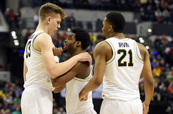 Moritz Wagner (13), Derrick Walton Jr. (10), and Zak Irvin (21)