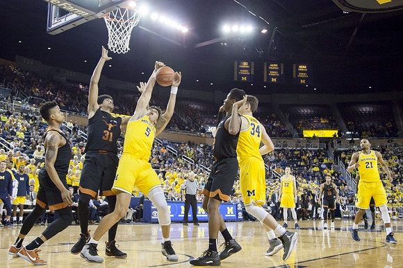 D.J. Wilson (5), Mark Donnal (34), Duncan Robinson (22), and Zak Irvin (21)