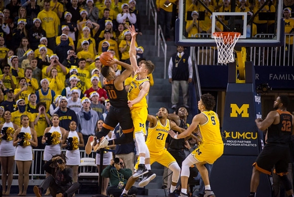 Moritz Wagner (13), Zak Irvin (21), and D.J. Wilson (5)