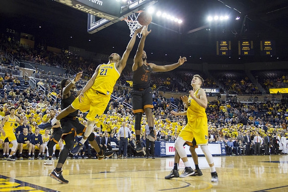 Zak Irvin (21), D.J. Wilson (5), and Moritz Wagner (13)
