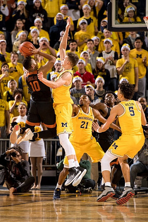 Moritz Wagner (13), Zak Irvin (21), and D.J. Wilson (5)