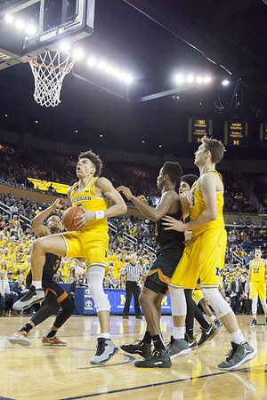 D.J. Wilson (5), Mark Donnal (34), and Duncan Robinson (22)
