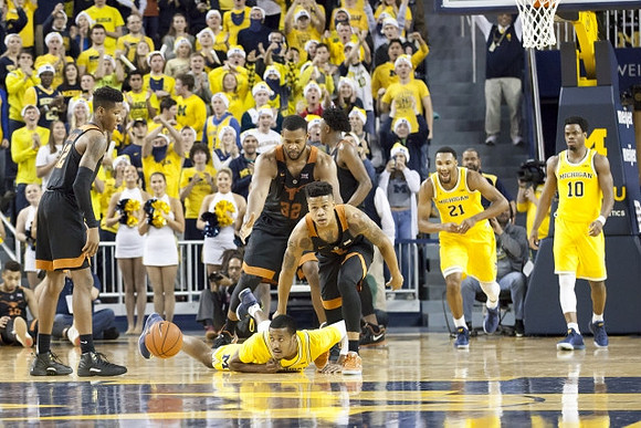 Muhammad-Ali Abdur-Rahkman (12), Zak Irvin (21), and Derrick Walton Jr. (10)