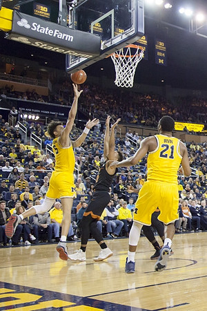 D.J. Wilson (5) and Zak Irvin (21)