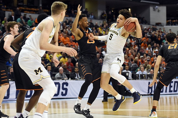 Moritz Wagner (13) and D.J. Wilson (5)
