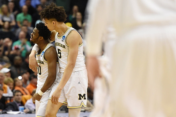 Derrick Walton Jr. (10) and D.J. Wilson (5)