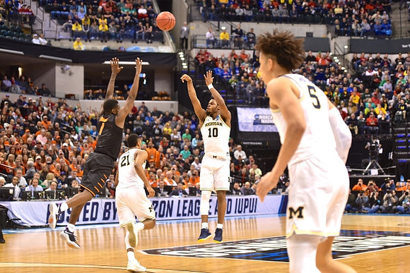 Zak Irvin (21), Derrick Walton Jr. (10), and D.J. Wilson (5)