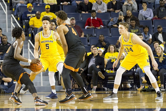 D.J. Wilson (5) and Mark Donnal (34)