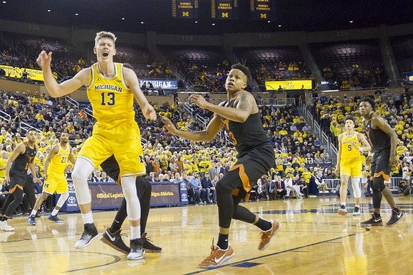 Moritz Wagner (13), Zak Irvin (21), and D.J. Wilson (5)