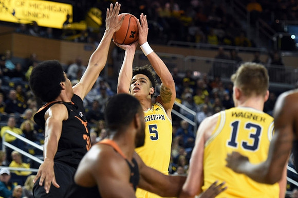 D.J. Wilson (5) and Moritz Wagner (13)