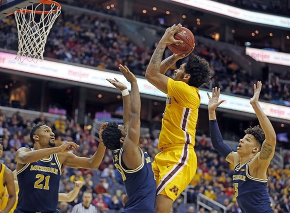 Zak Irvin (21), Derrick Walton Jr. (10), and D.J. Wilson (5)