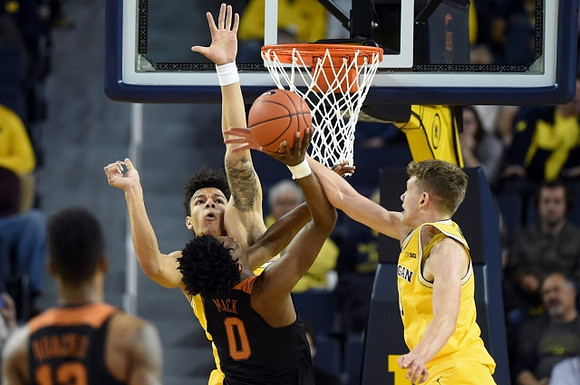 D.J. Wilson (5) and Moritz Wagner (13)