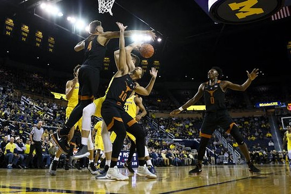 D.J. Wilson (5) and Zak Irvin (21)