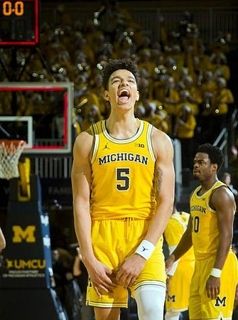 D.J. Wilson (5) and Derrick Walton Jr. (10)