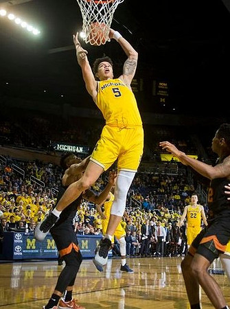 D.J. Wilson (5) and Duncan Robinson (22)