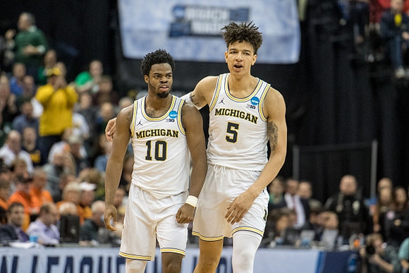Derrick Walton Jr. (10) and D.J. Wilson (5)