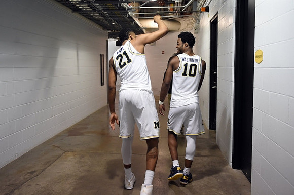 Zak Irvin (21) and Derrick Walton Jr. (10)
