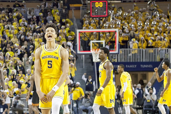 D.J. Wilson (5), Derrick Walton Jr. (10), Muhammad-Ali Abdur-Rahkman (12), and Zak Irvin (21)