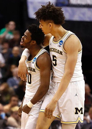 Derrick Walton Jr. (10) and D.J. Wilson (5)