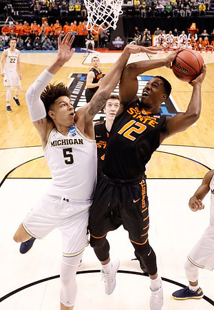D.J. Wilson (5) and Duncan Robinson (22)
