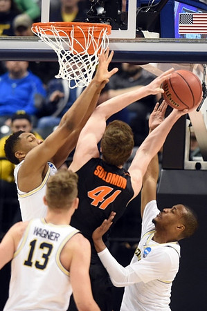 Zak Irvin (21), Moritz Wagner (13), and Muhammad-Ali Abdur-Rahkman (12)