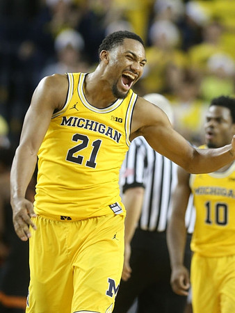 Zak Irvin (21) and Derrick Walton Jr. (10)