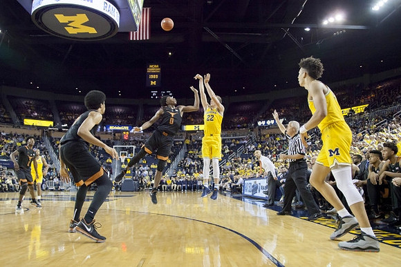 Duncan Robinson (22) and D.J. Wilson (5)