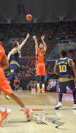 Mark Donnal (34) and Derrick Walton Jr. (10)