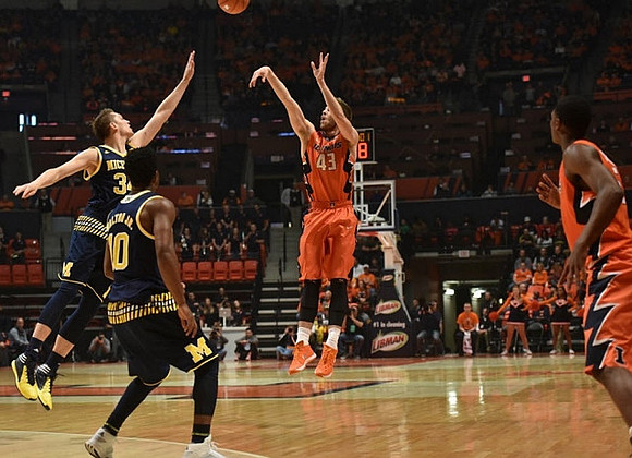 Mark Donnal (34) and Derrick Walton Jr. (10)