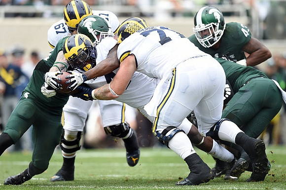 Kyle Kalis (67), De'Veon Smith (4), and Ben Braden (71)