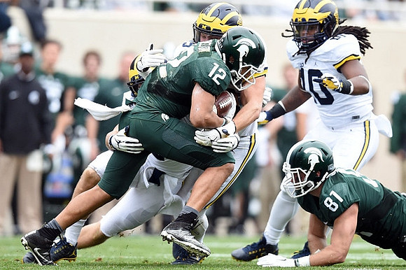 Chase Winovich (15) and Devin Bush (10)