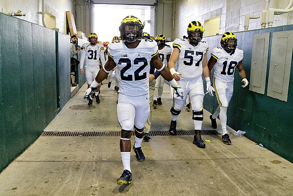 Scott Sypniewski (31), Karan Higdon (22), Patrick Kugler (57), and Nick Eubanks (18)