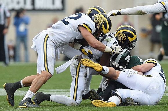 Mason Cole (52) and Jehu Chesson (86)
