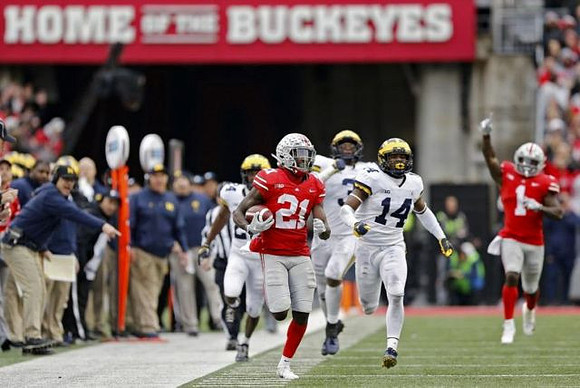 Lavert Hill (24), Rashan Gary (3), and Josh Metellus (14)