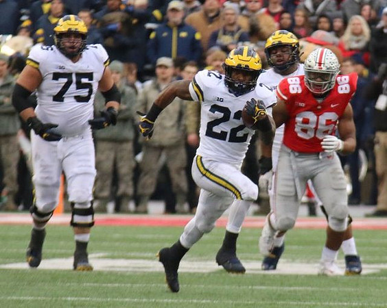 Jon Runyan Jr. (75) and Karan Higdon (22)
