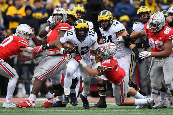 Chris Evans (12), Ben Bredeson (74), and Jon Runyan Jr. (75)