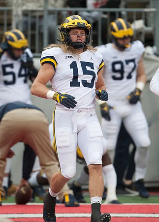 Carl Myers (54), Chase Winovich (15), and Aidan Hutchinson (97)