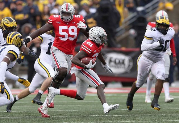 Chase Winovich (15) and Michael Dwumfour (50)