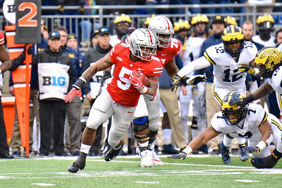 Khaleke Hudson (7), Josh Ross (12), and Devin Bush (10)