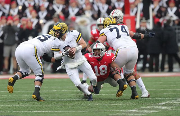 Jon Runyan Jr. (75), Shea Patterson (2), and Ben Bredeson (74)