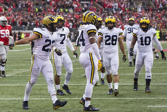 Tyree Kinnel (23), Khaleke Hudson (7), Josh Metellus (14), Brandon Watson (28), Bryan Mone (90), and Devin Bush (10)